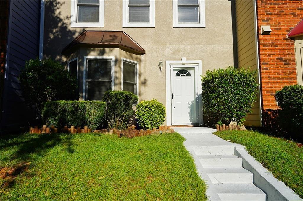 a front view of a house with a yard