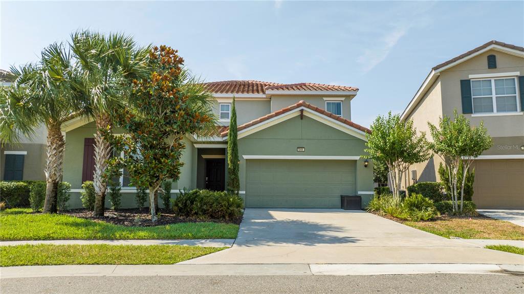 a front view of a house with a yard and garage