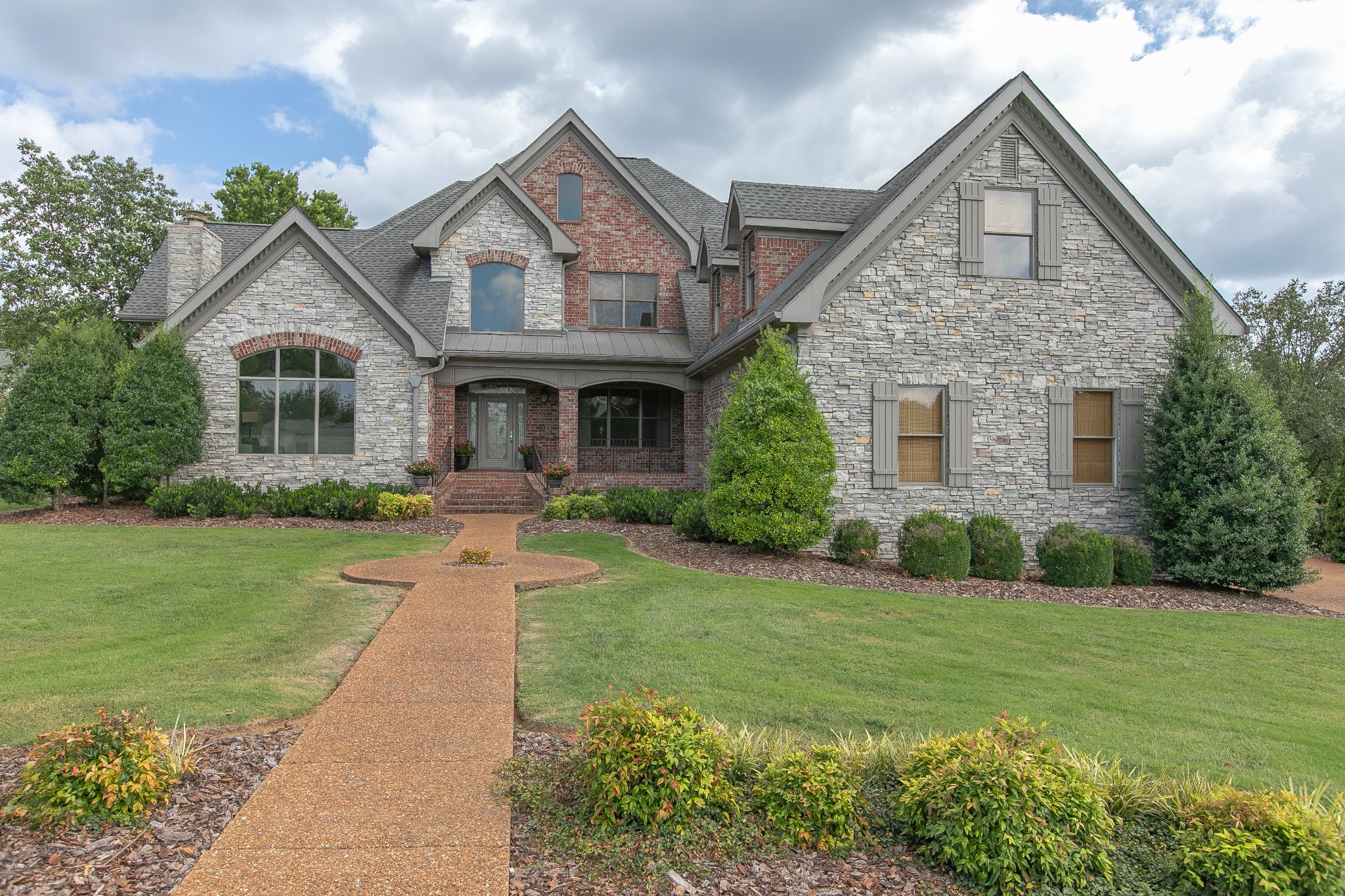 a front view of a house with garden