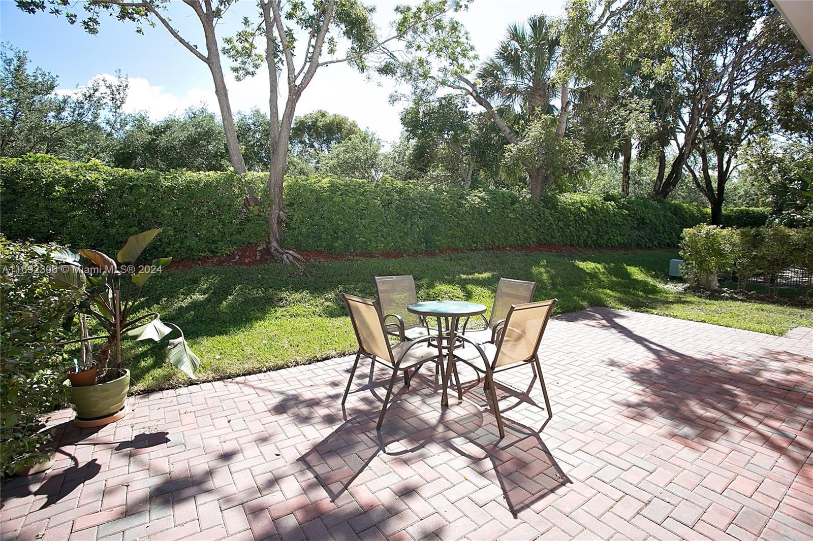 a view of a backyard with a table and chairs