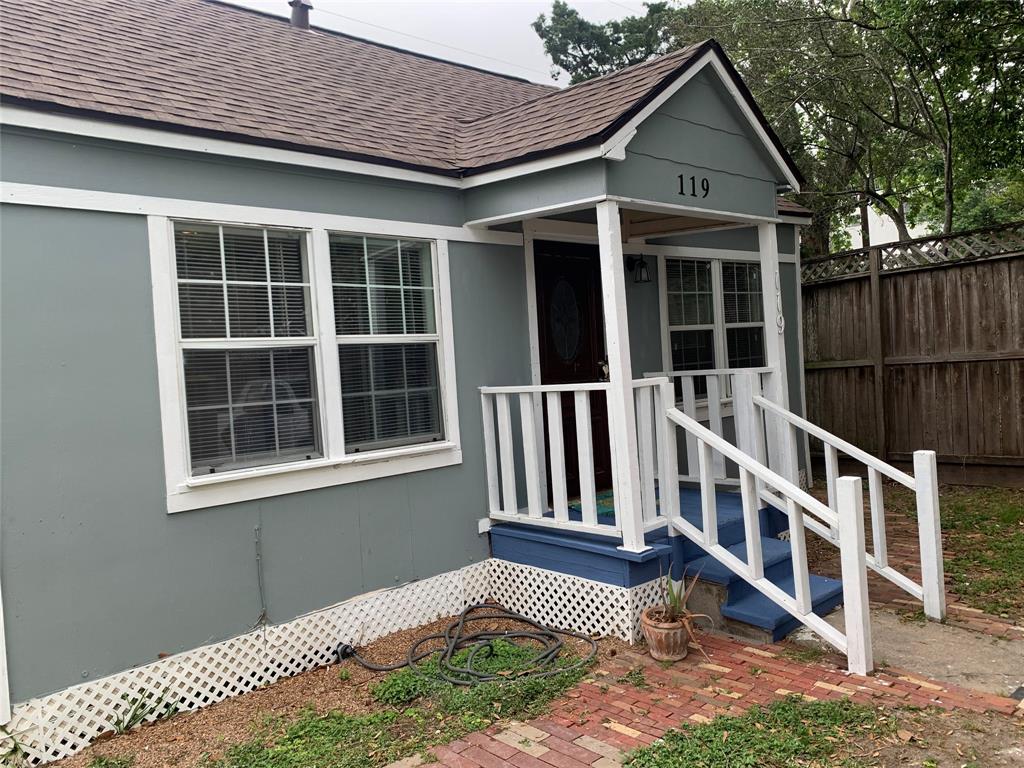 a view of a house with wooden fence