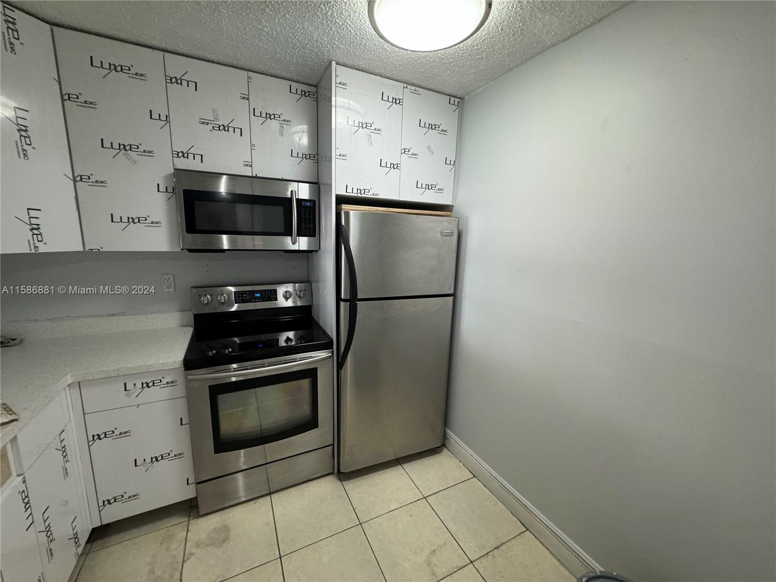 a kitchen with stainless steel appliances a refrigerator sink and cabinets