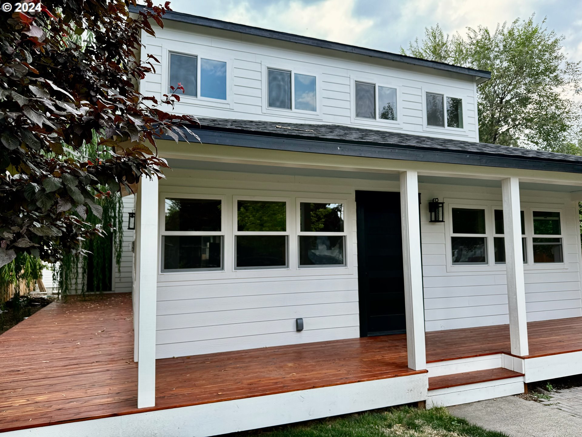 a view of a house with a window and wooden fence