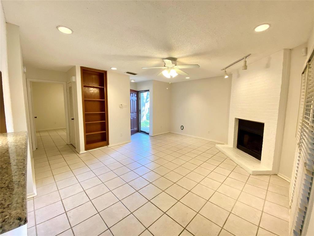 a view of a livingroom with a fireplace and a chandelier