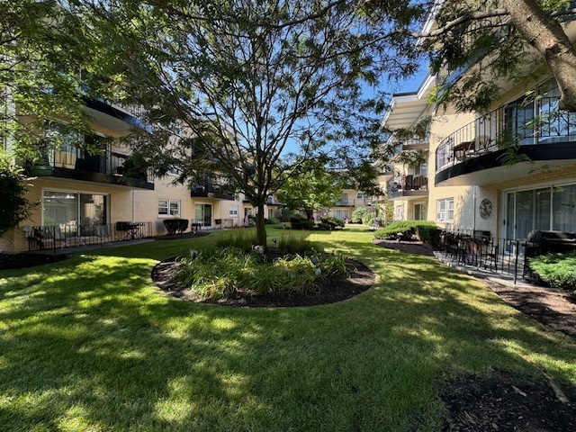 a view of a house with backyard and sitting area