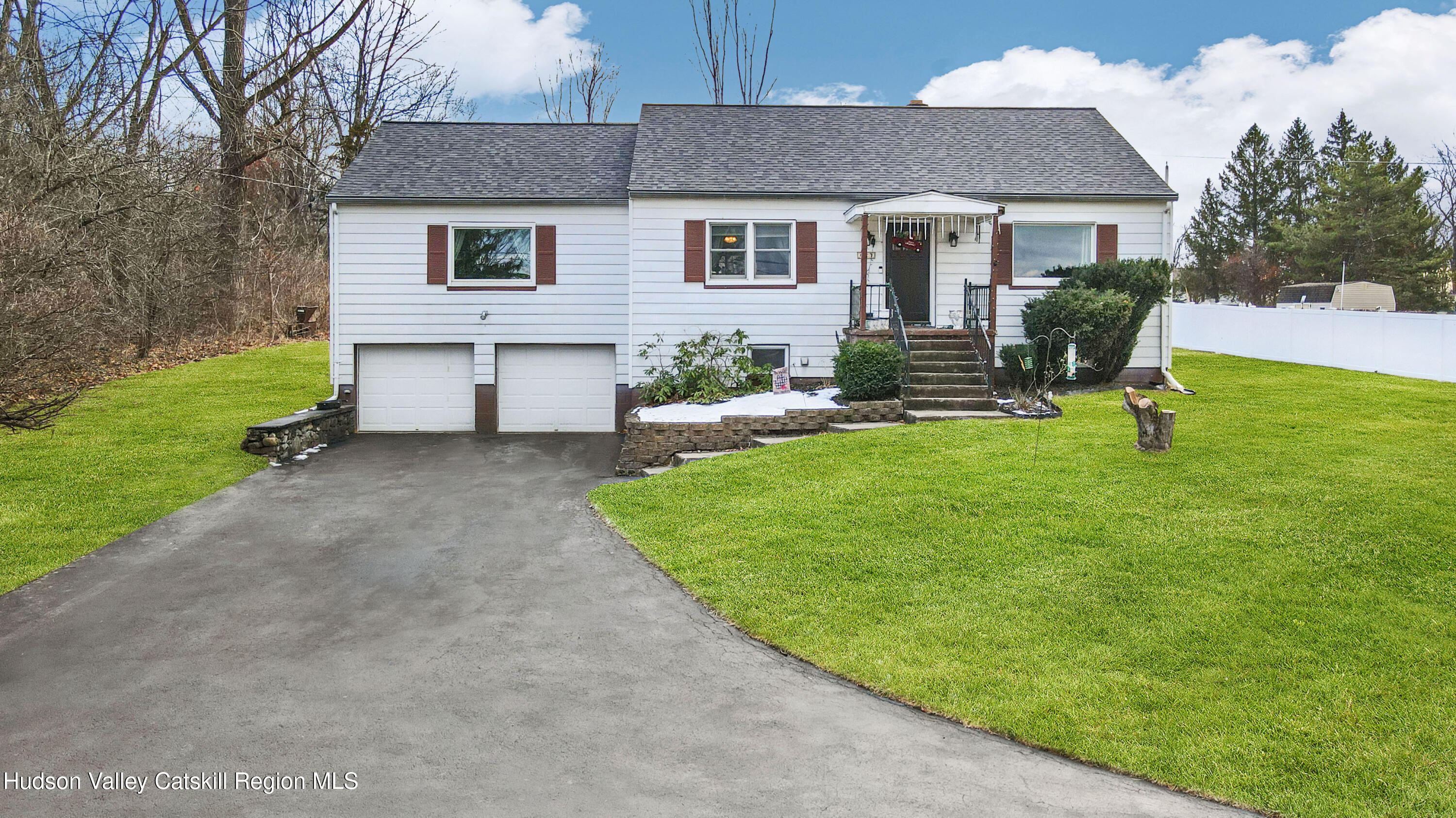 a front view of house with yard and green space