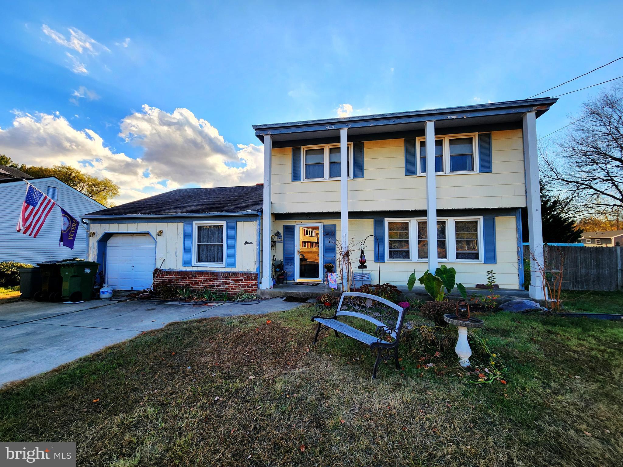 a house view with a sitting space and garden