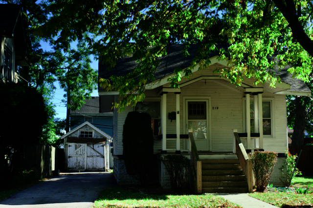 a front view of a house with garden