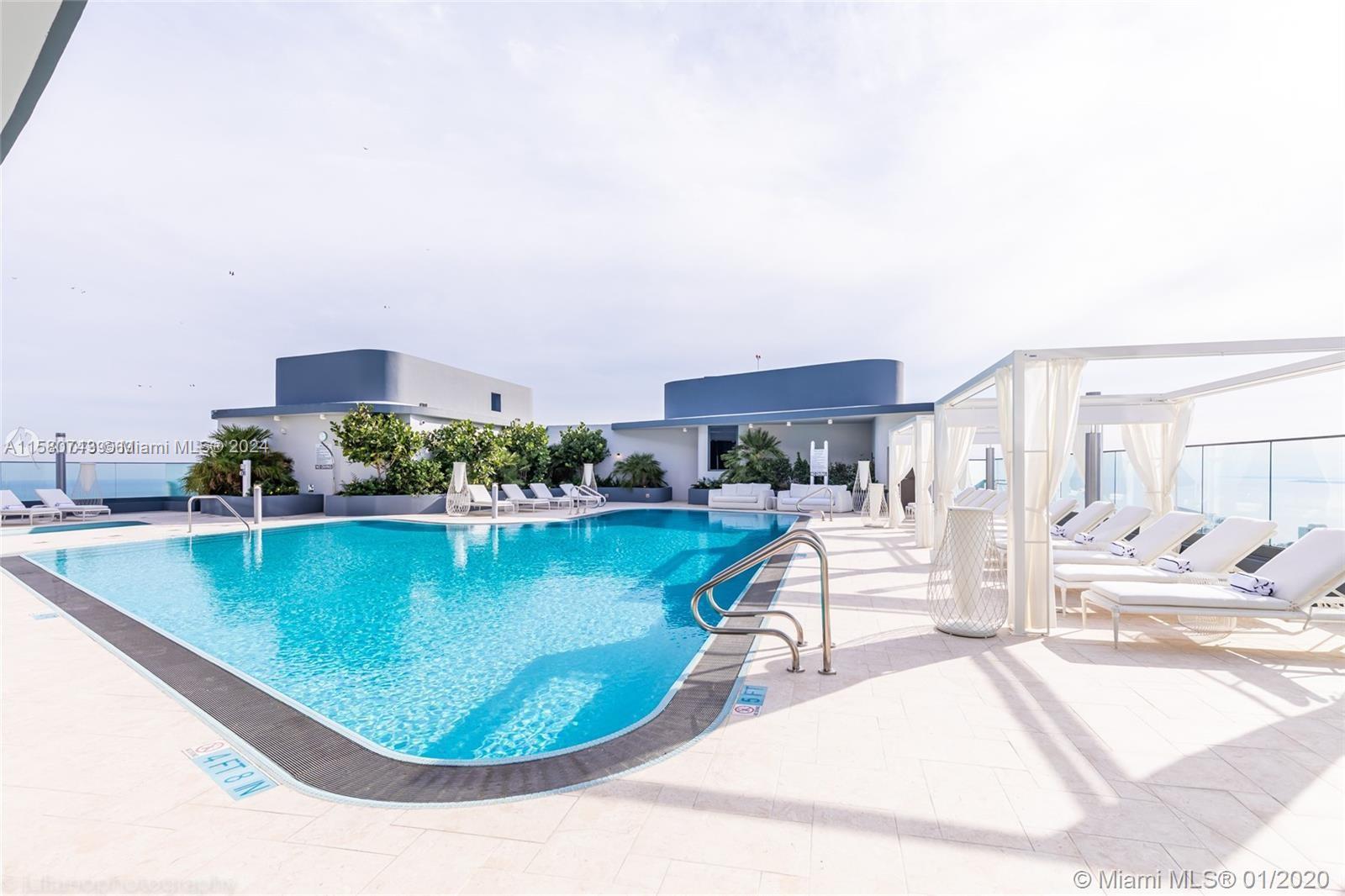 a view of a swimming pool with outdoor seating