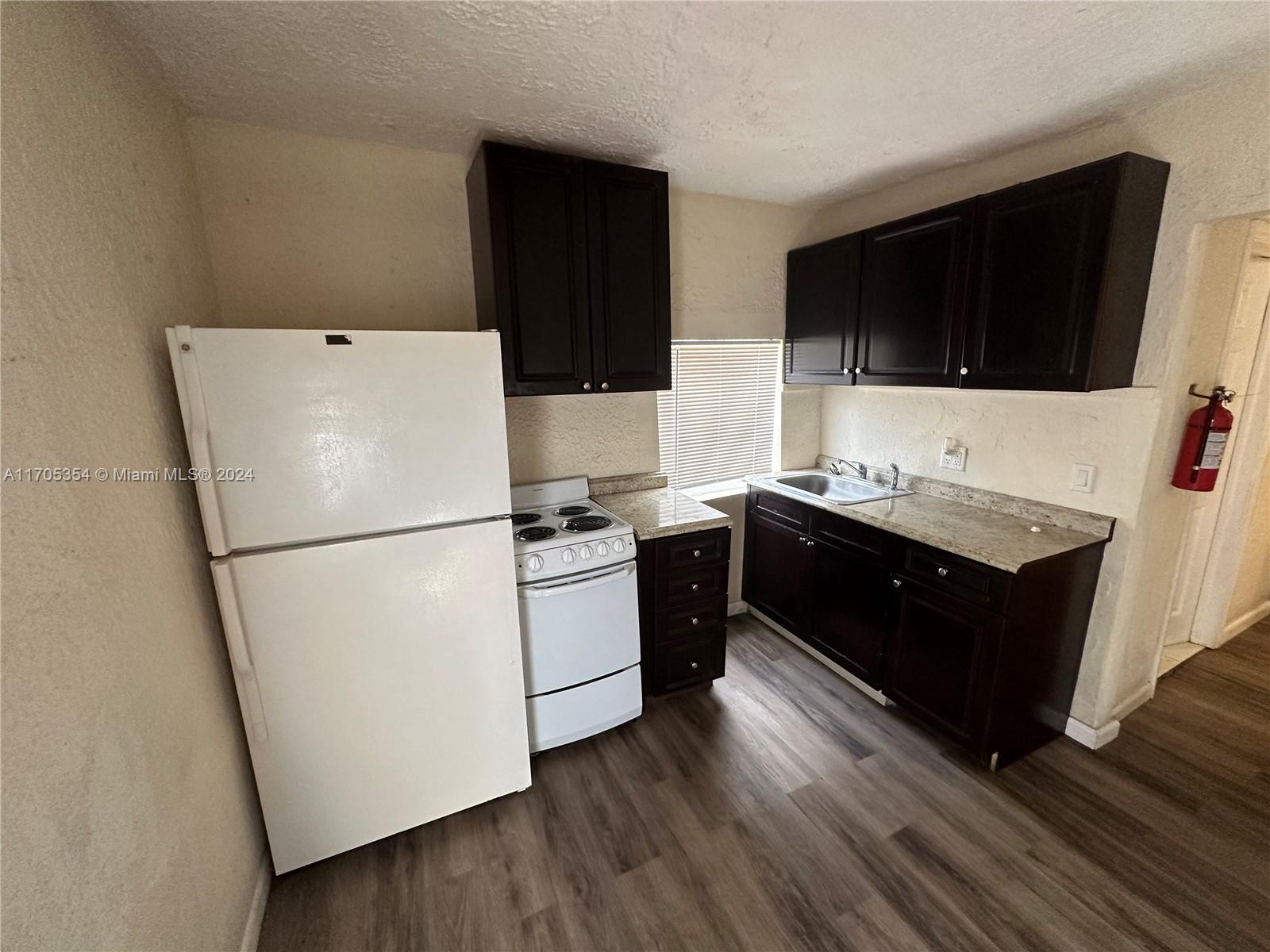 a kitchen with a refrigerator and a microwave