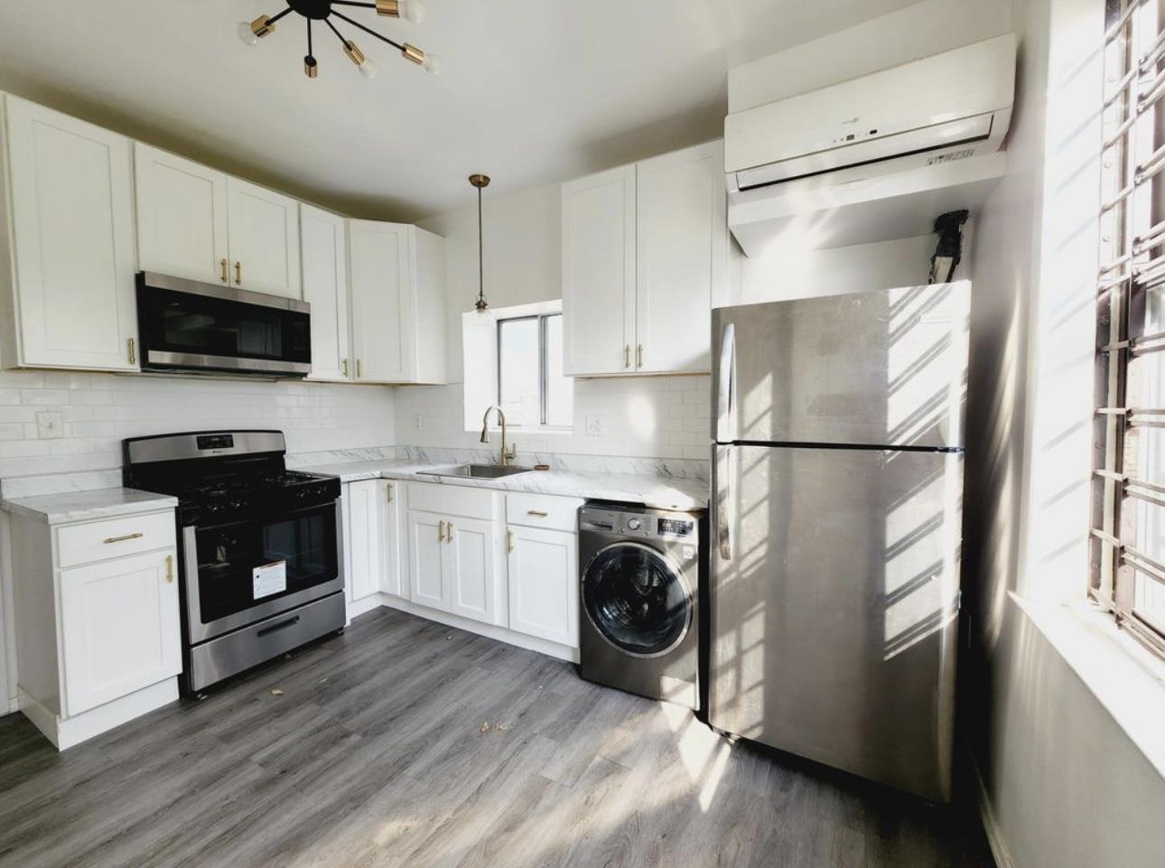 a kitchen with a refrigerator stove and white cabinets