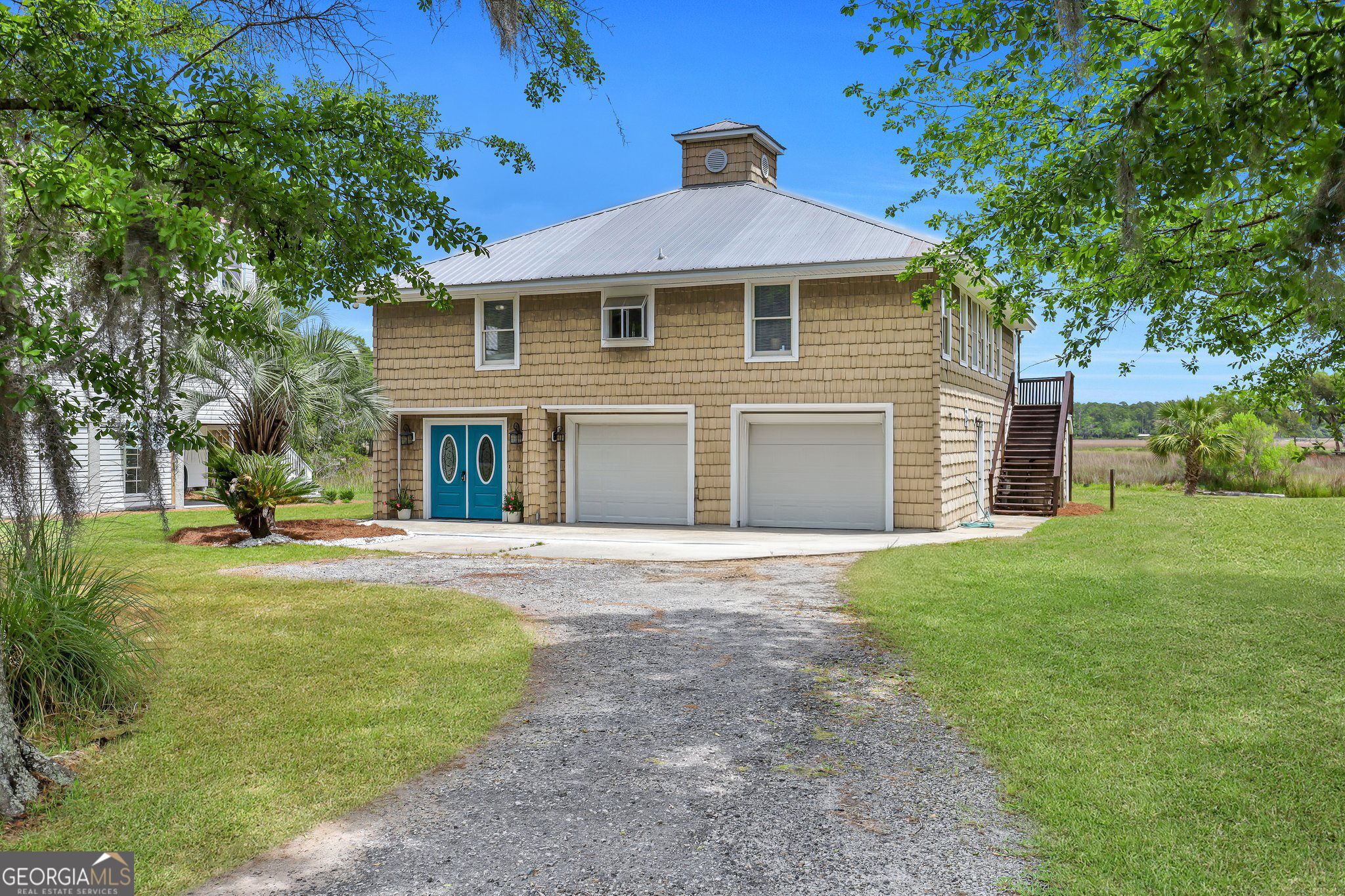 a front view of a house with a garden