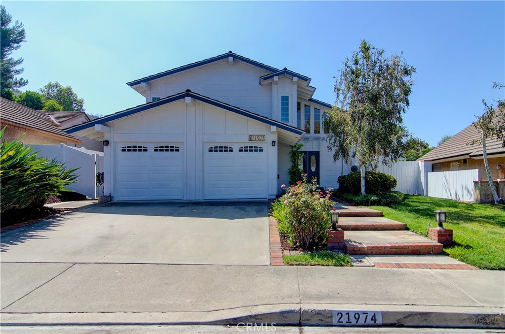 a front view of a house with a yard and a garage