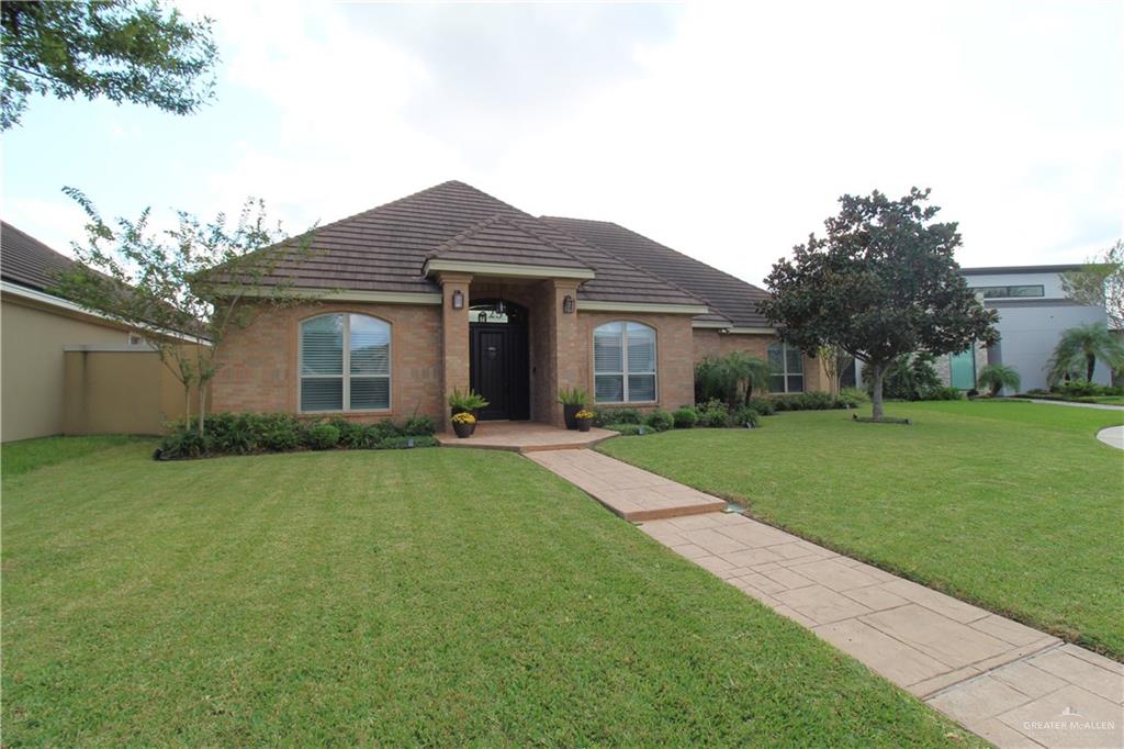 a front view of house with yard and green space