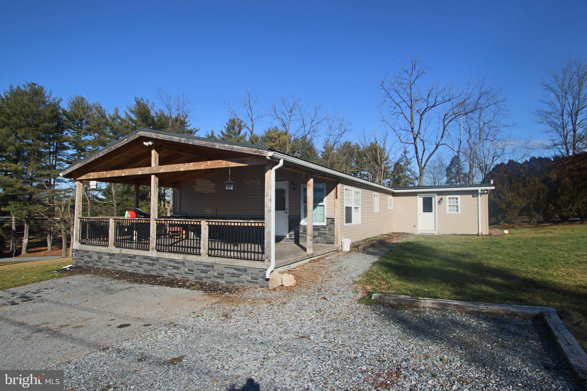 a view of a house with a yard and roof