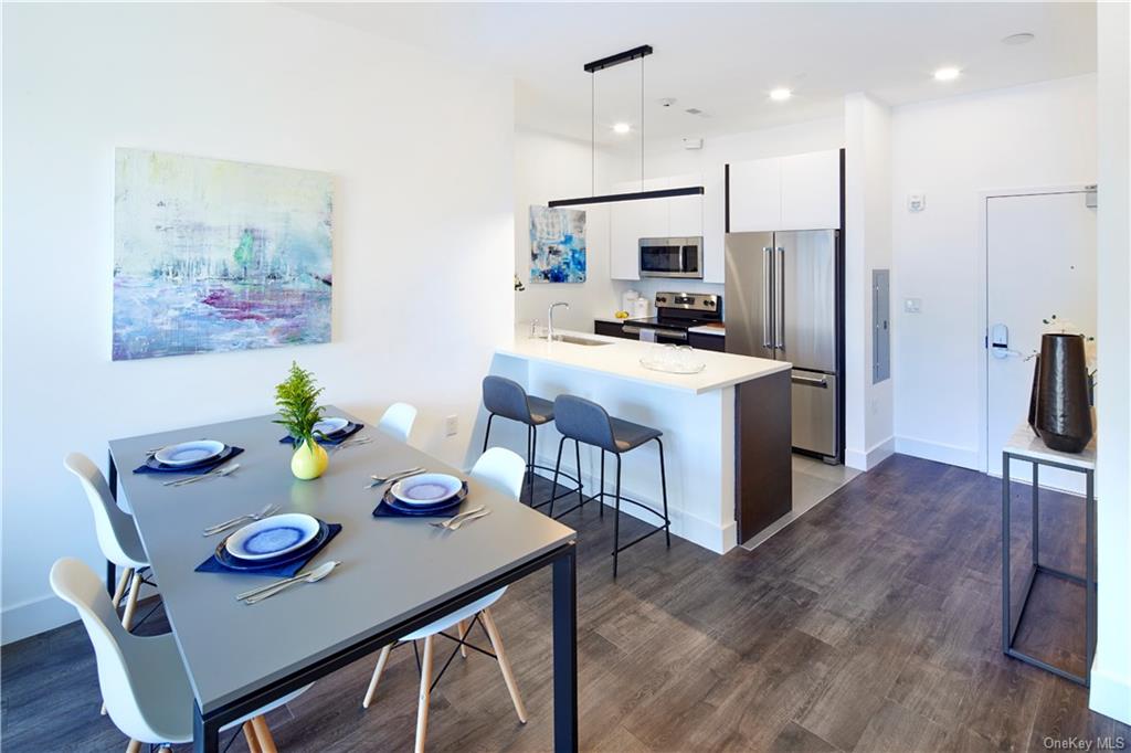 Dining space featuring electric panel, dark hardwood / wood-style floors, and sink