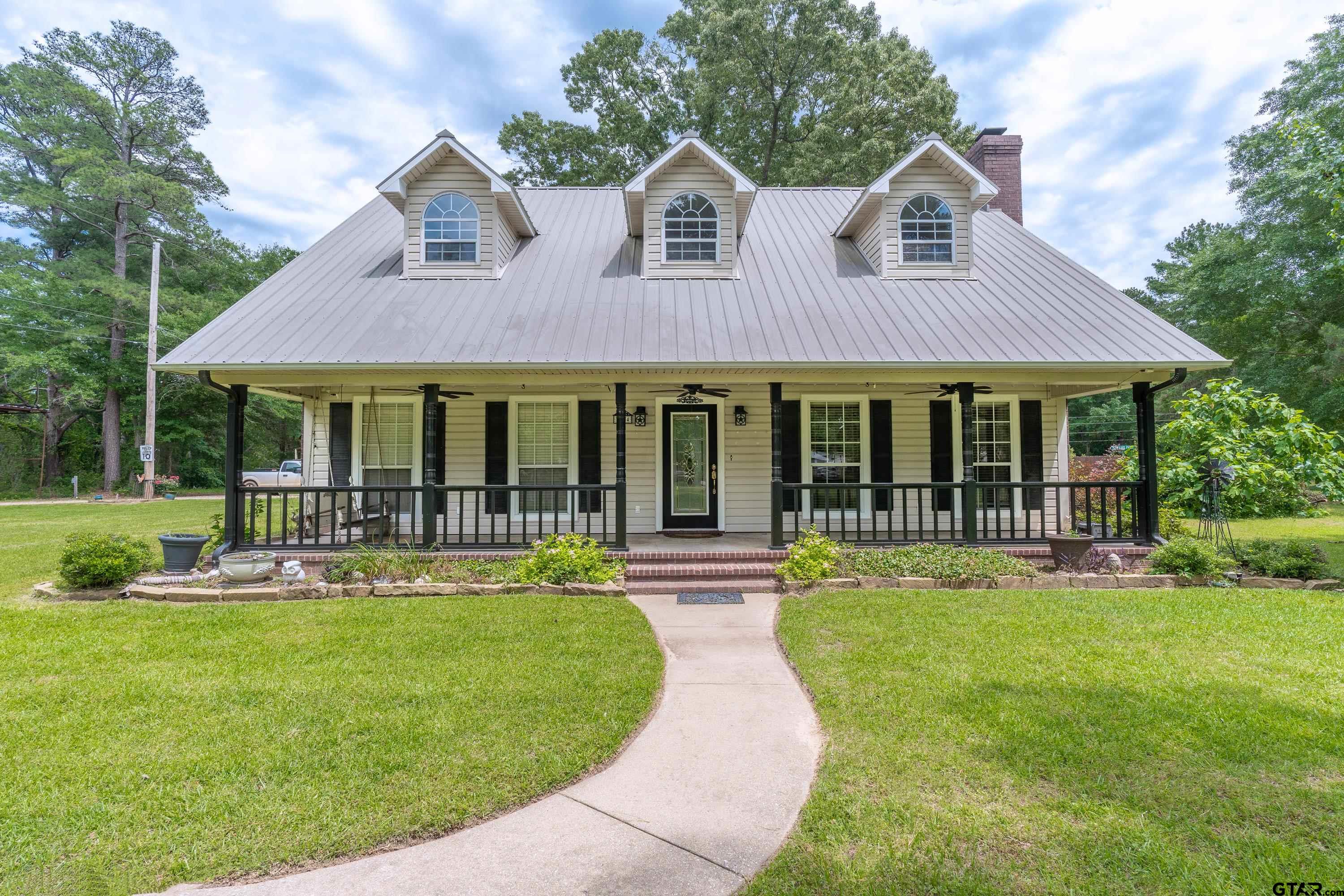 a front view of a house with a yard table and chairs