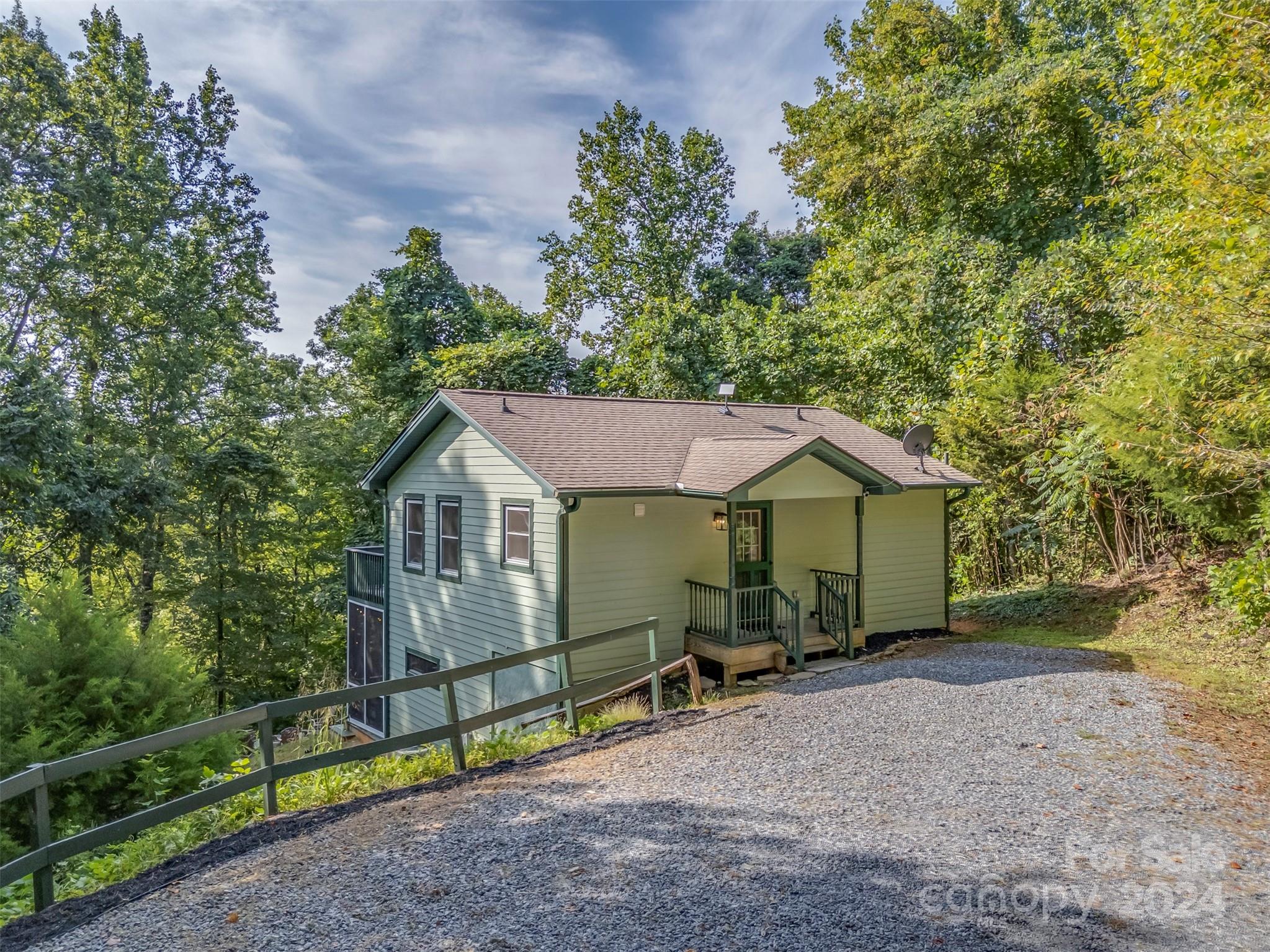 a view of a house with a backyard and a tree