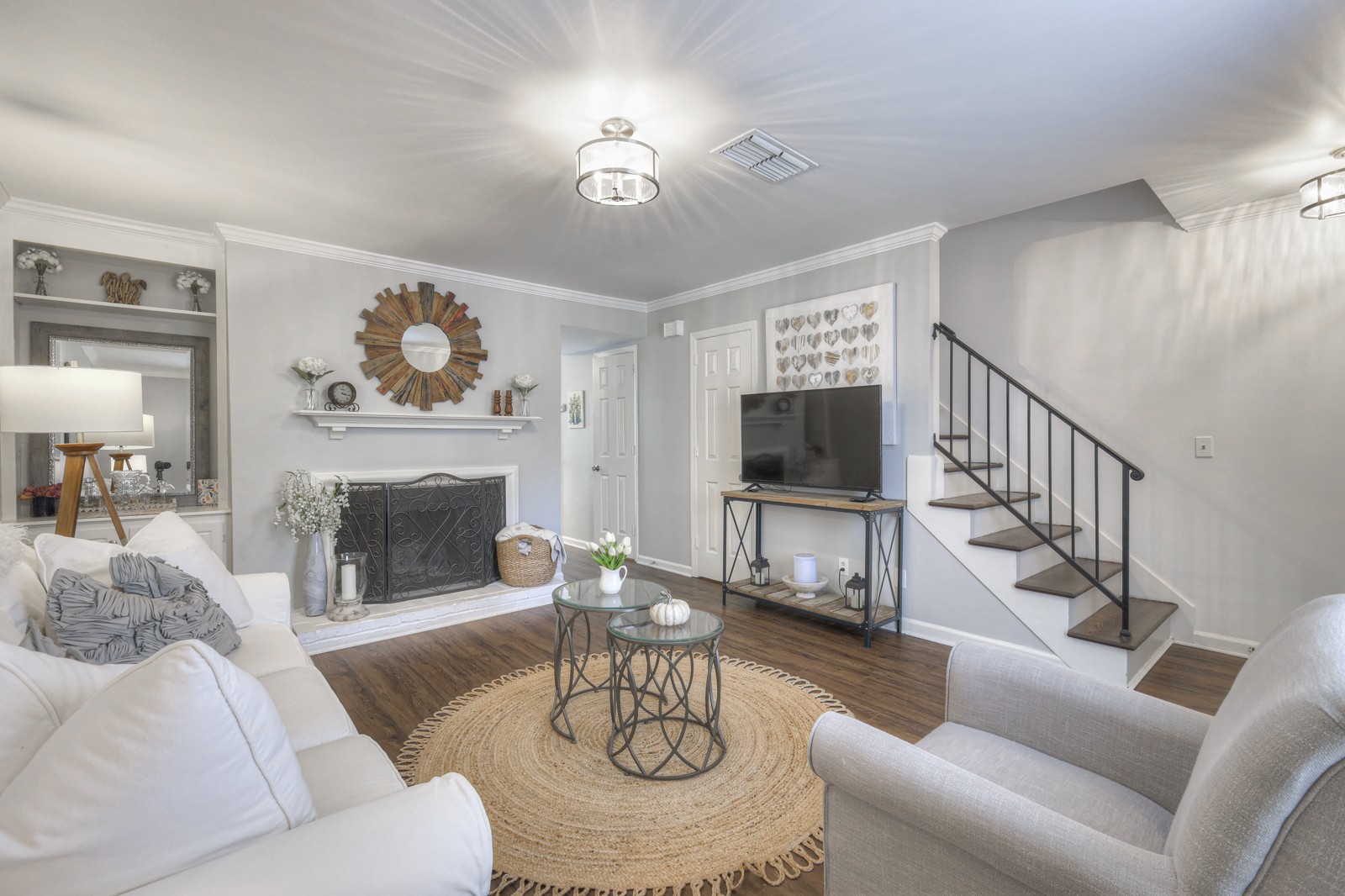 a living room with furniture a fireplace and a flat screen tv