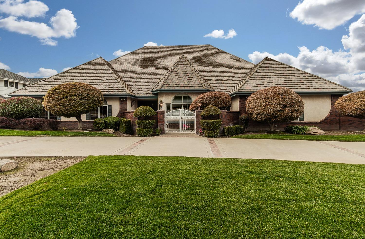 a front view of a house with garden