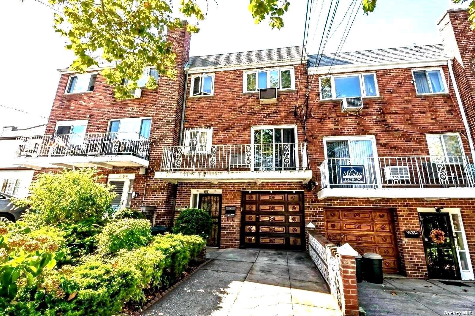 a front view of a residential apartment building with a yard