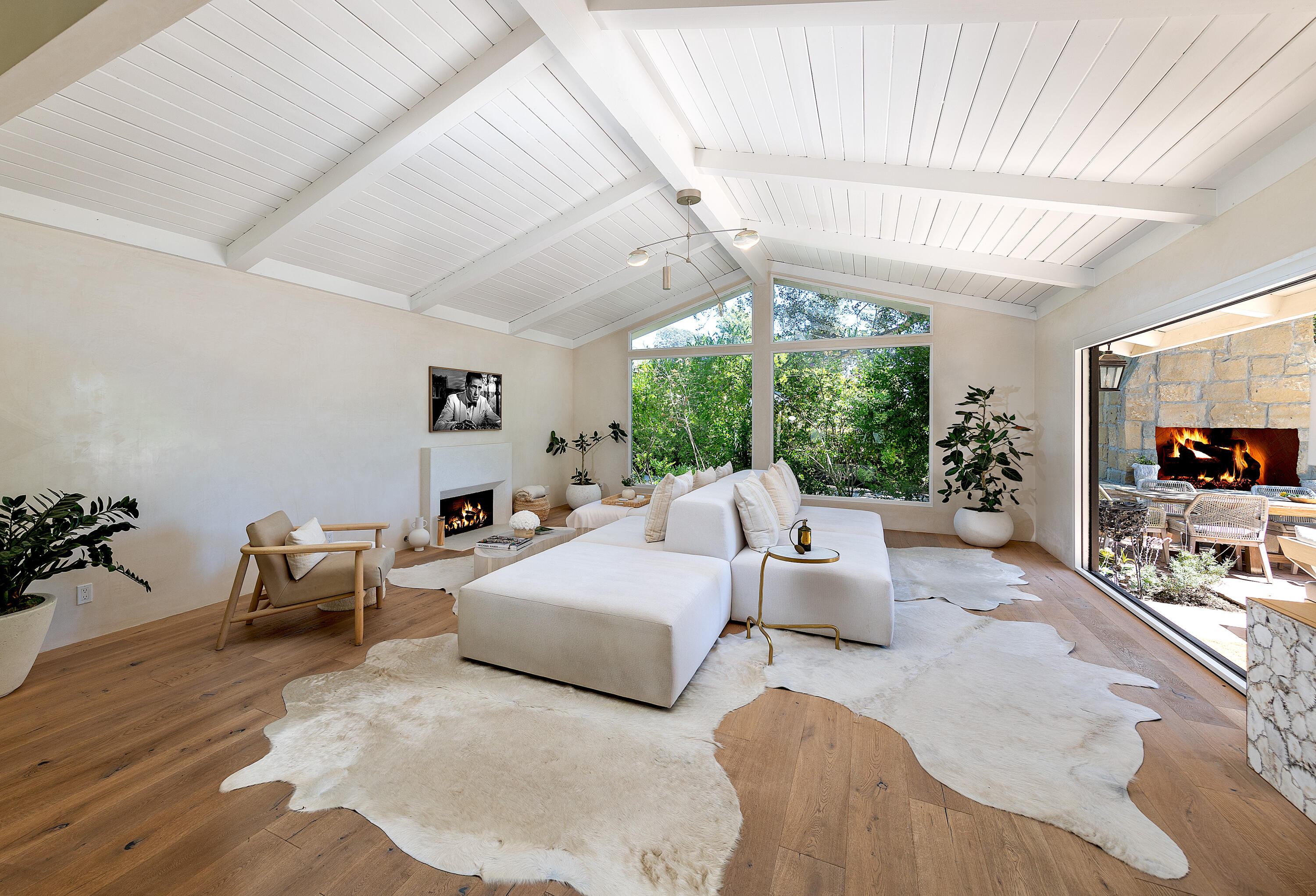 a bedroom with furniture and a large window