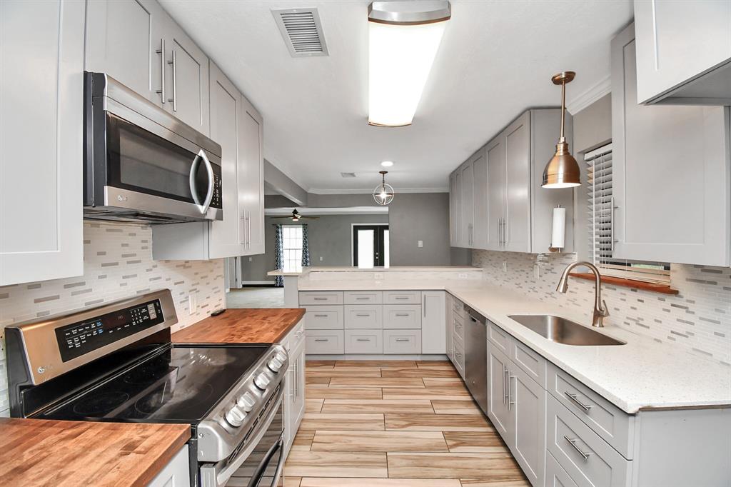 a kitchen with stainless steel appliances granite countertop a sink and stove top oven