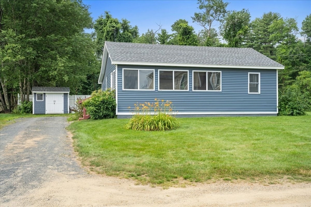 a house that has a big yard plants and large trees