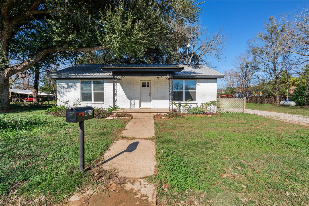 View of front of property with a front yard