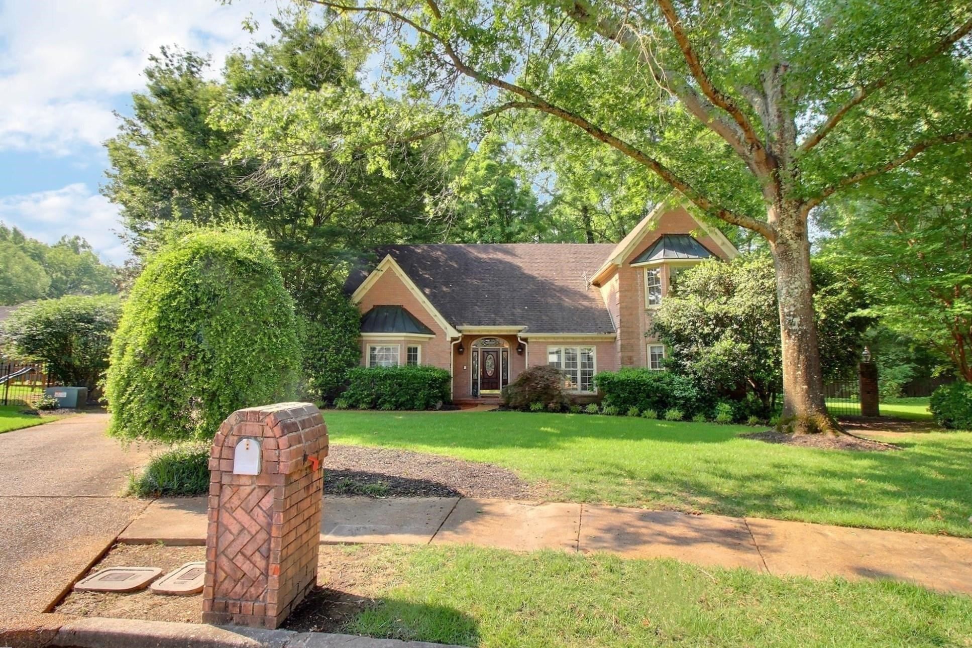 a front view of a house with a garden