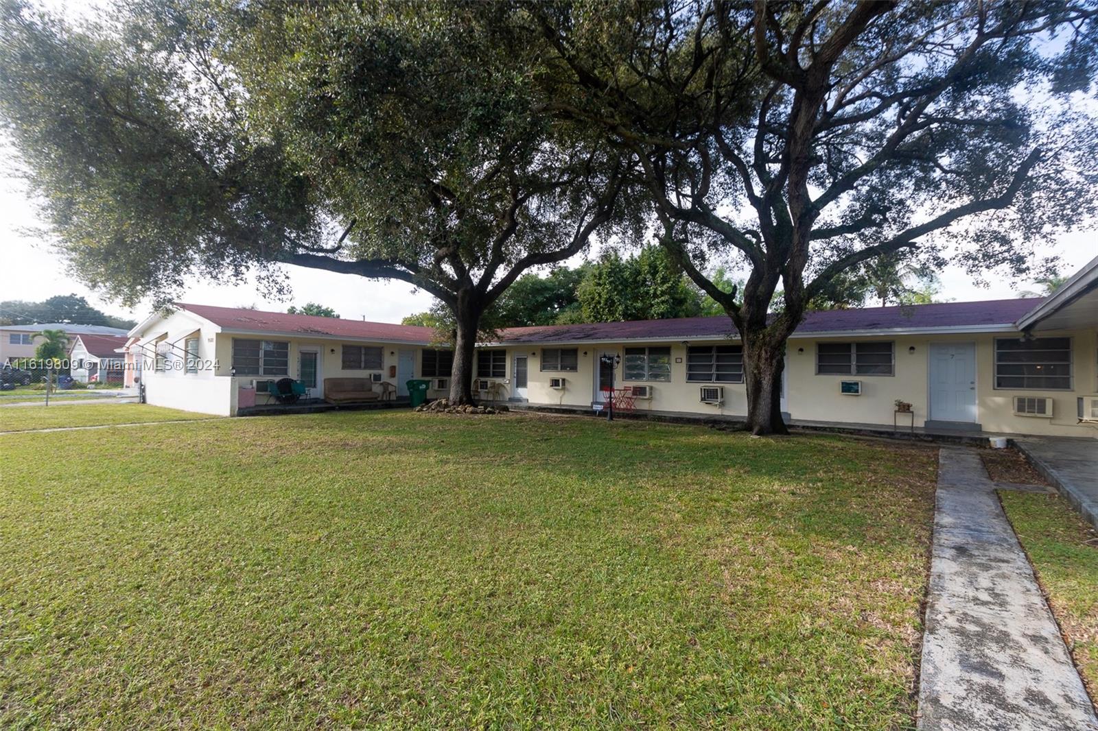 a front view of a house with a garden