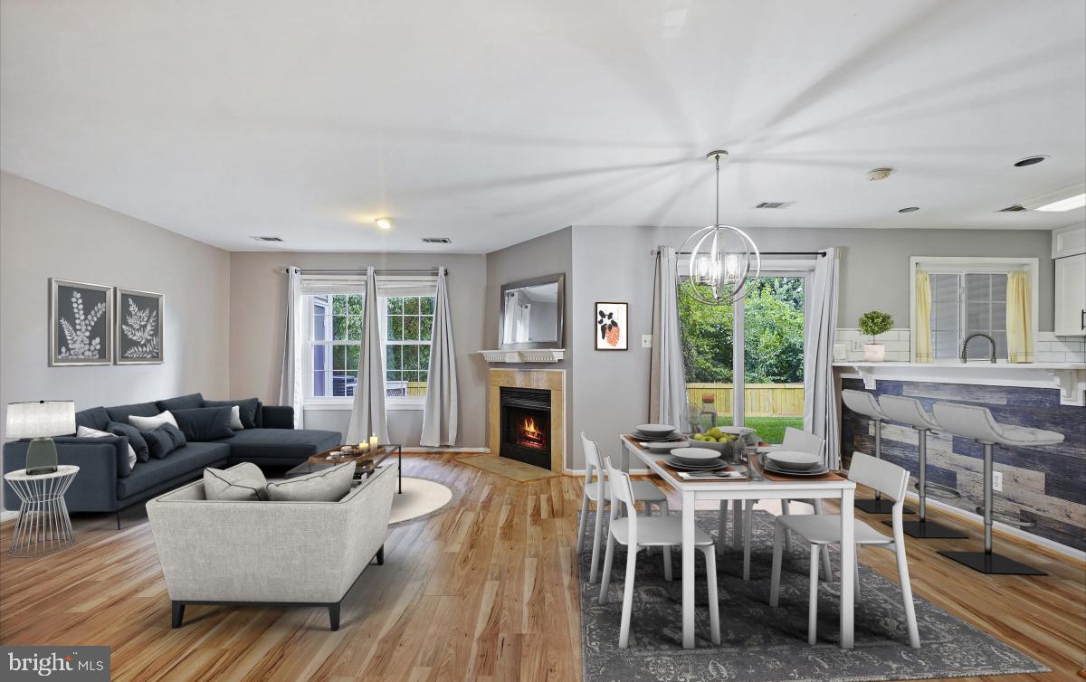 a living room with furniture a fireplace and a floor to ceiling window