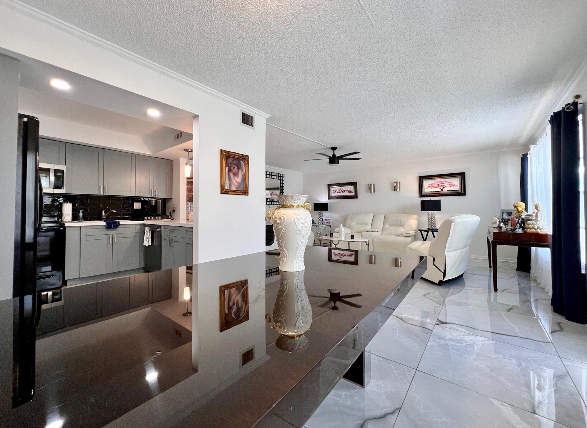 a living room with furniture and kitchen view