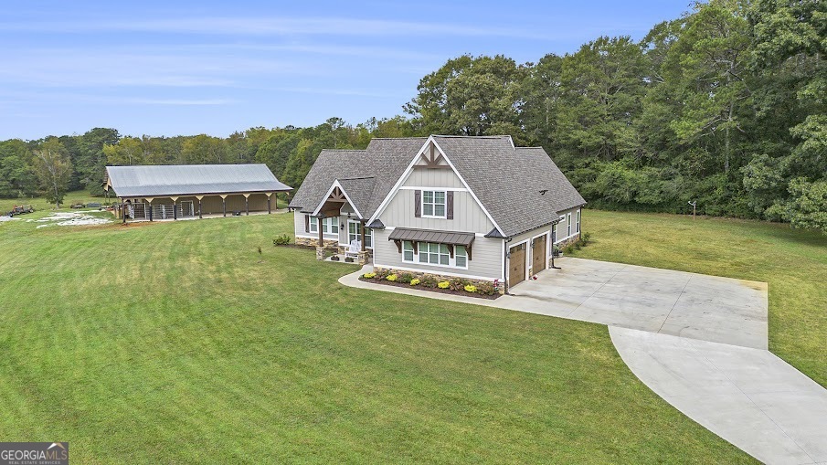 an aerial view of residential houses with outdoor space and trees