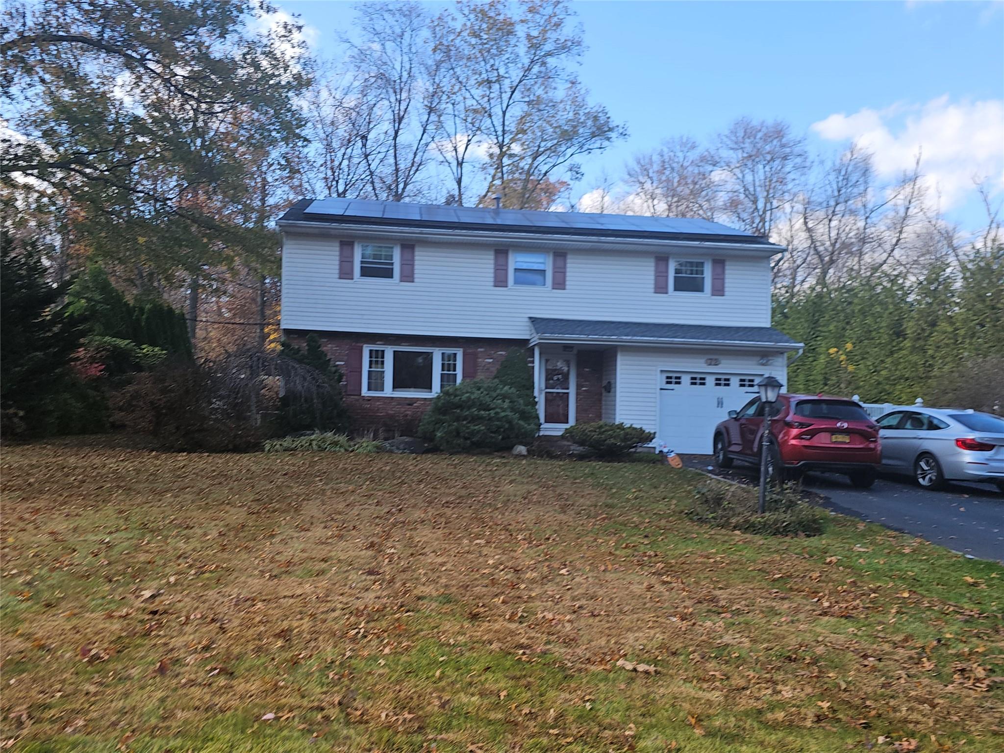 a view of a house with a yard