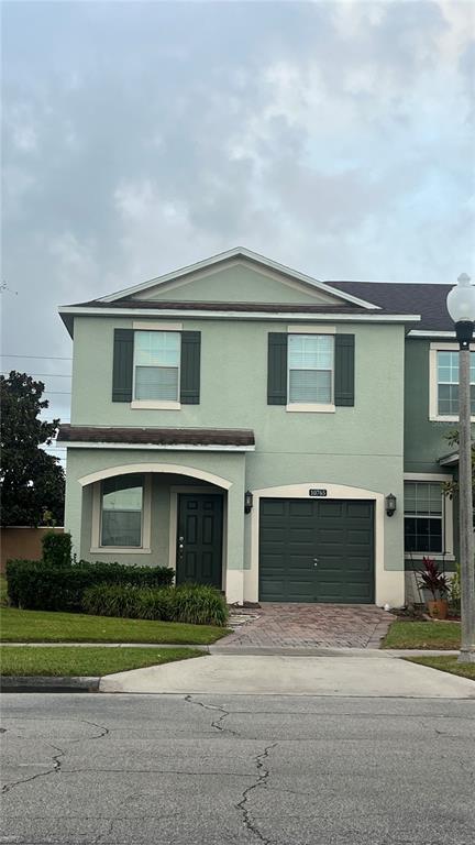 a front view of a house with a yard and garage