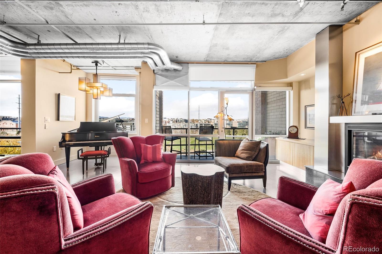 a living room with furniture and a floor to ceiling window