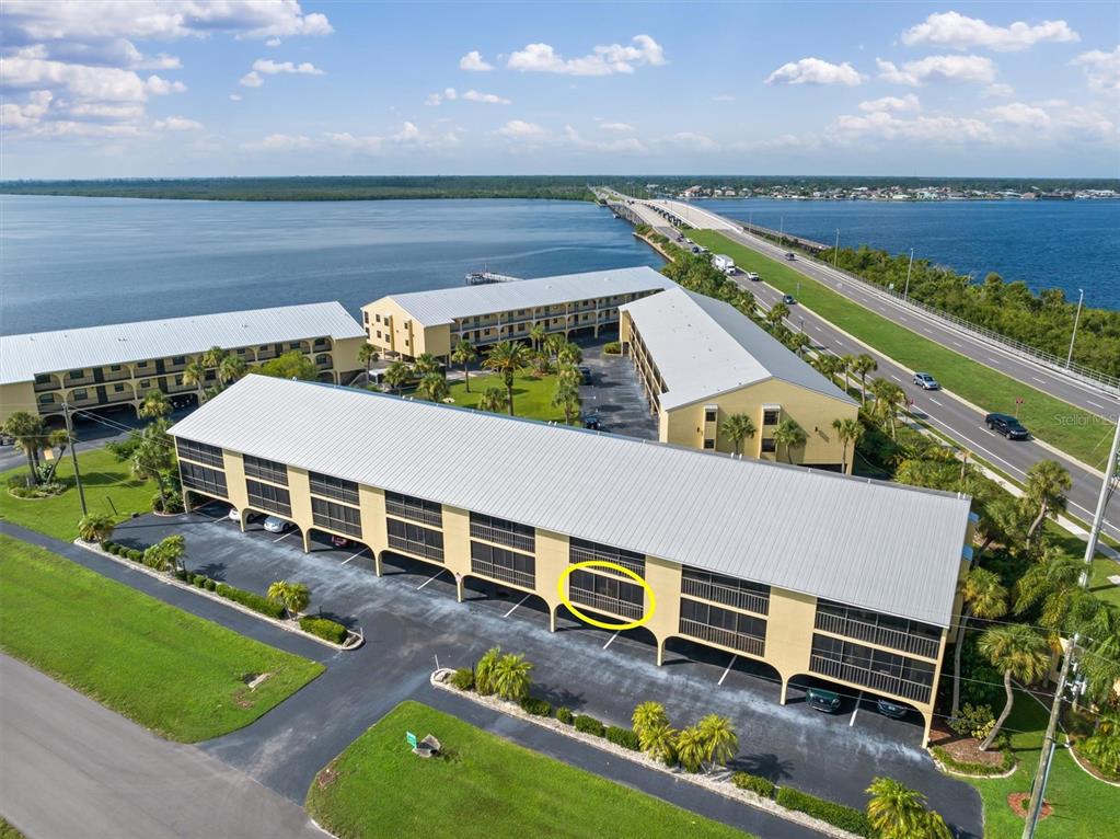 an aerial view of a house with a garden and lake view