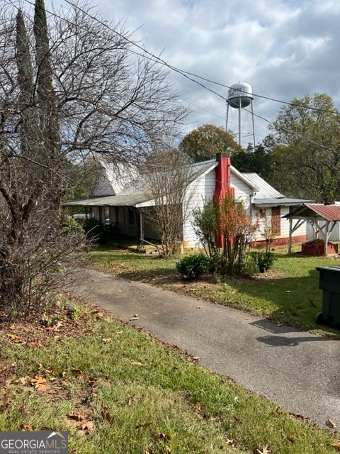 a front view of a house with a yard and a garage