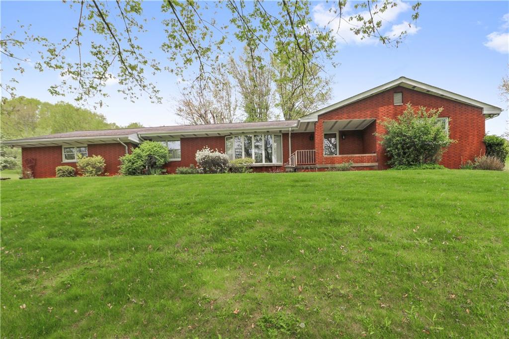 a front view of house with yard and green space