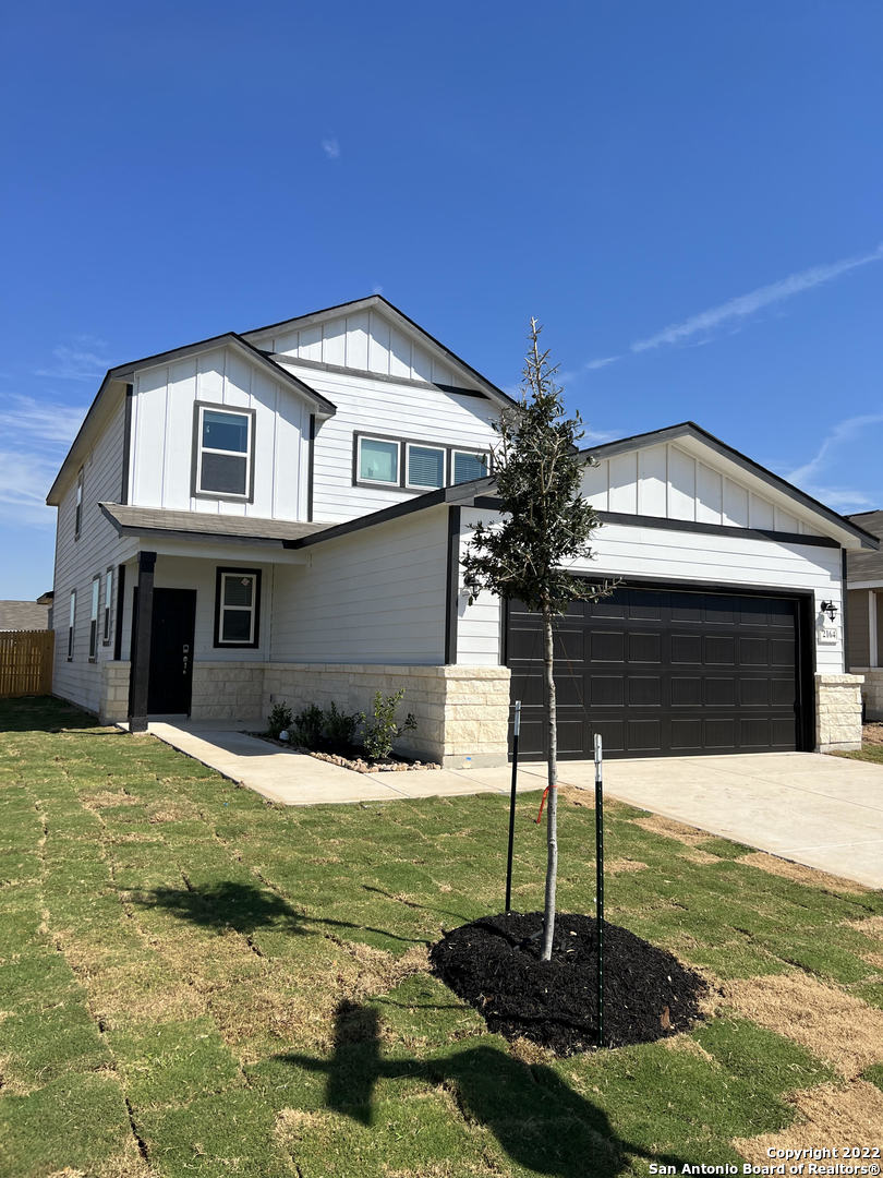 a front view of a house with a yard