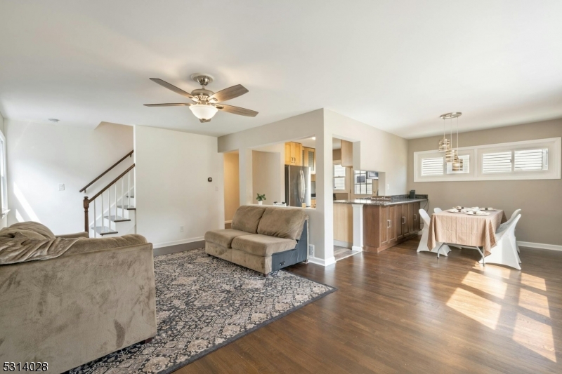 a living room with furniture and kitchen view