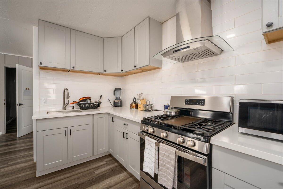 a kitchen with cabinets appliances and a sink