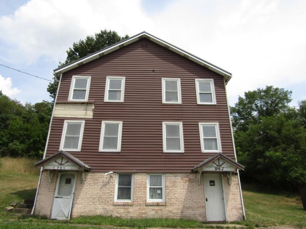 a front view of a house with a yard