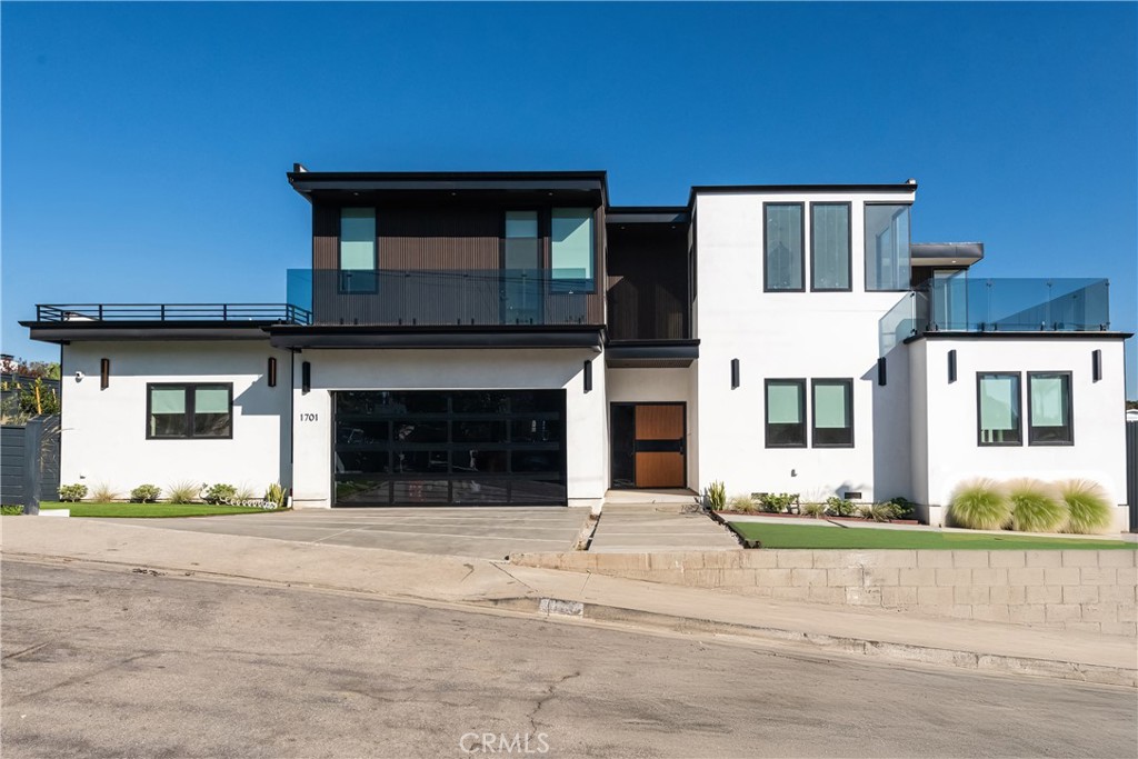 a front view of a house with a road