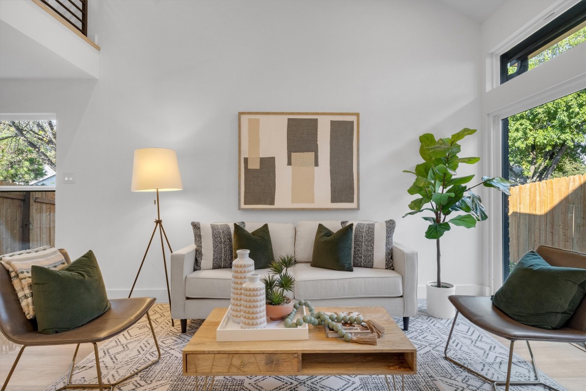 a living room with furniture and a potted plant