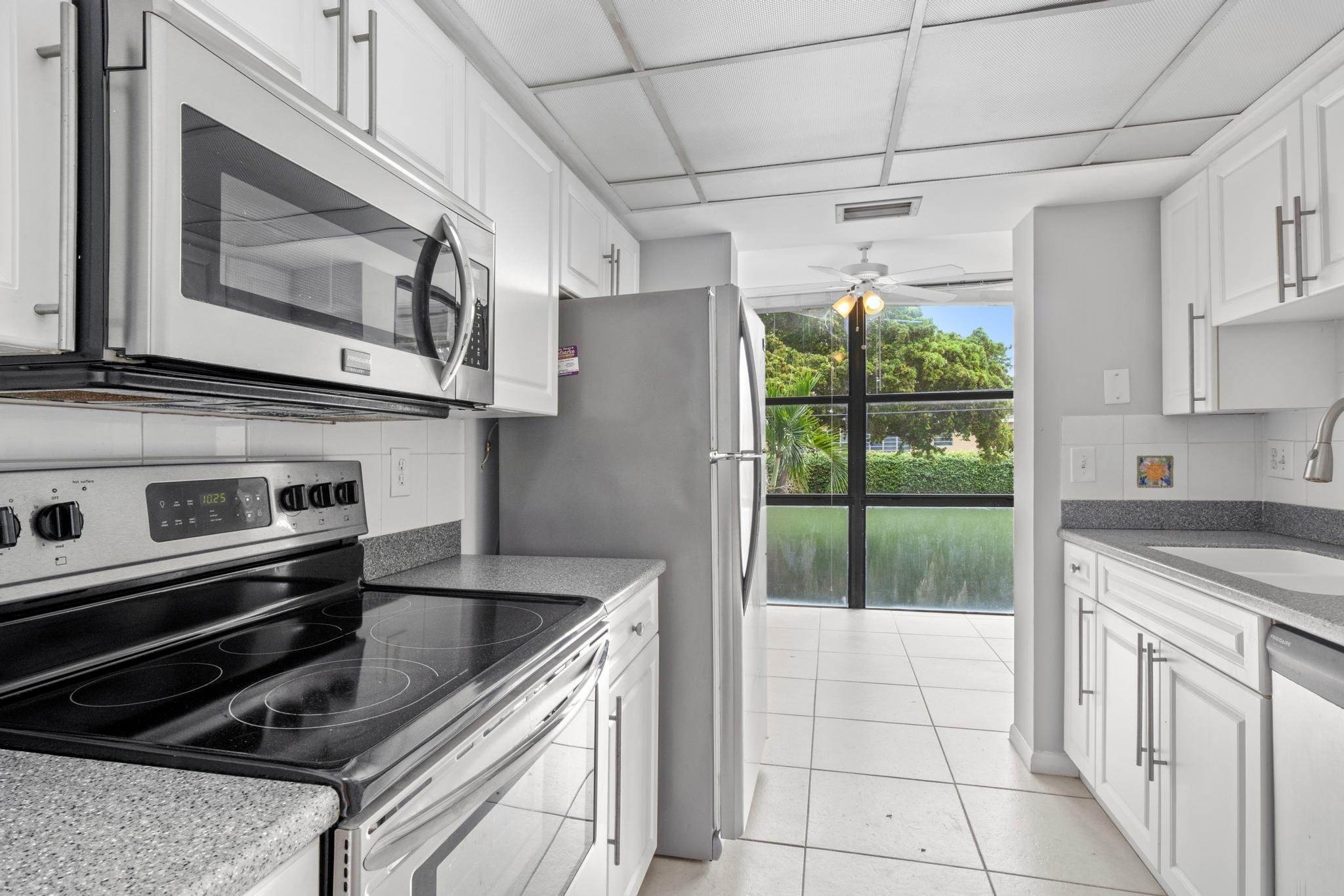 a kitchen with a stove a sink and a refrigerator