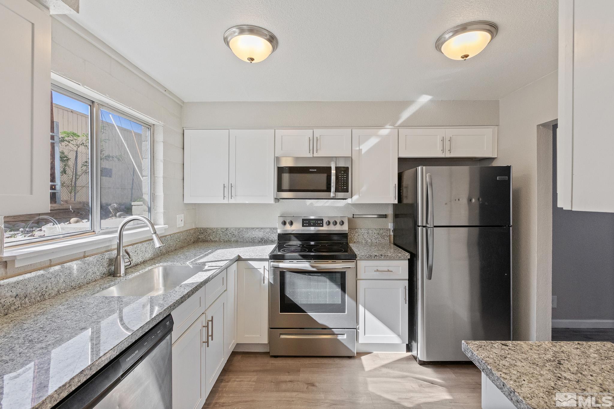 a kitchen with a sink stove and refrigerator