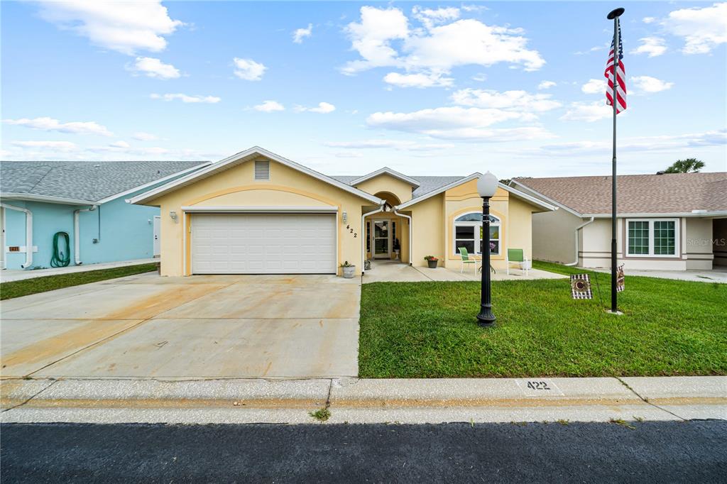 a front view of a house with a yard and garage