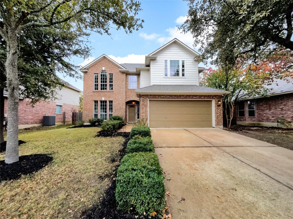 a front view of a house with a yard and garage